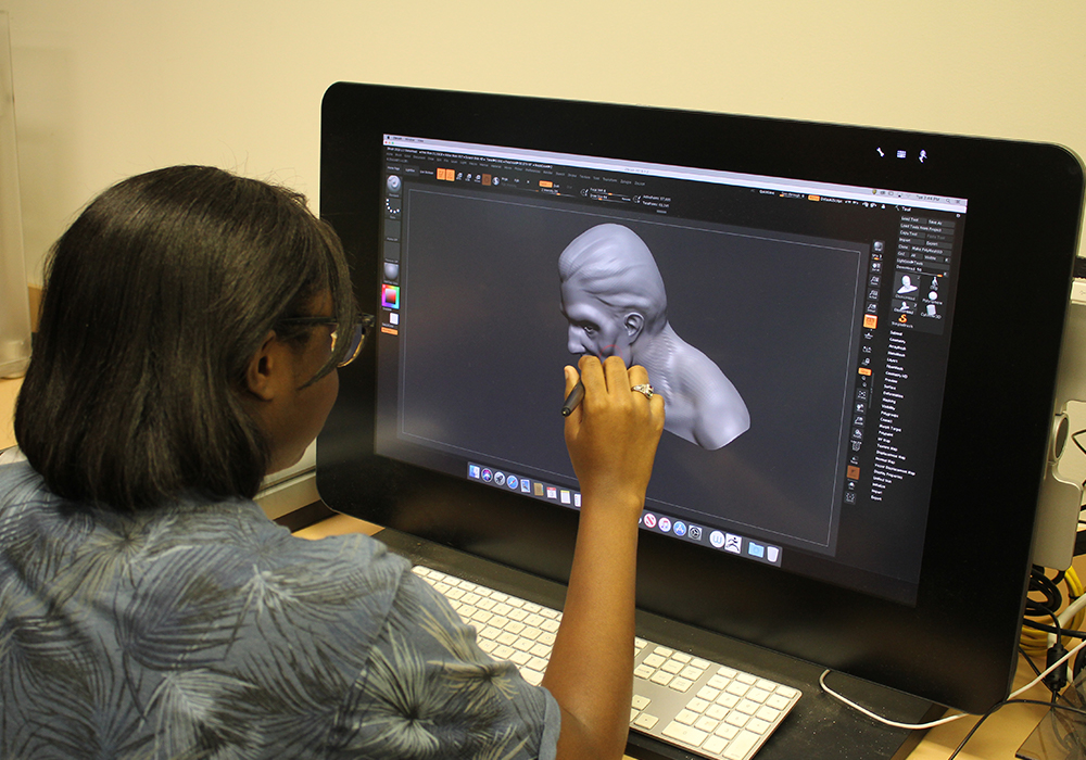 Student creating a digital drawing on a tablet