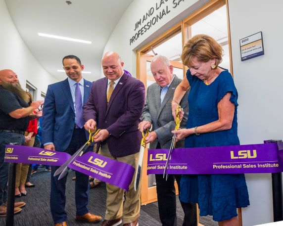 Donors cut the ribbon outside the PSI Sales Lab