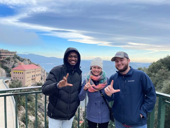 Three students on top of Monserrat in Spain. 