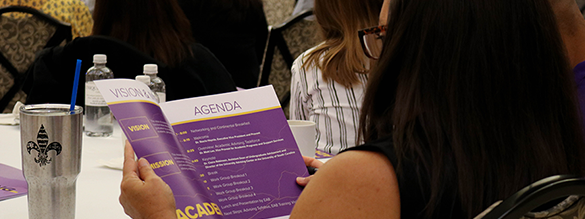 Student reading the Advising Summit agenda