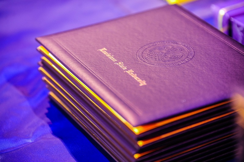 a stack of LSU diploma covers