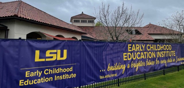 Banner hanging on fence outside early childhood lab preschool
