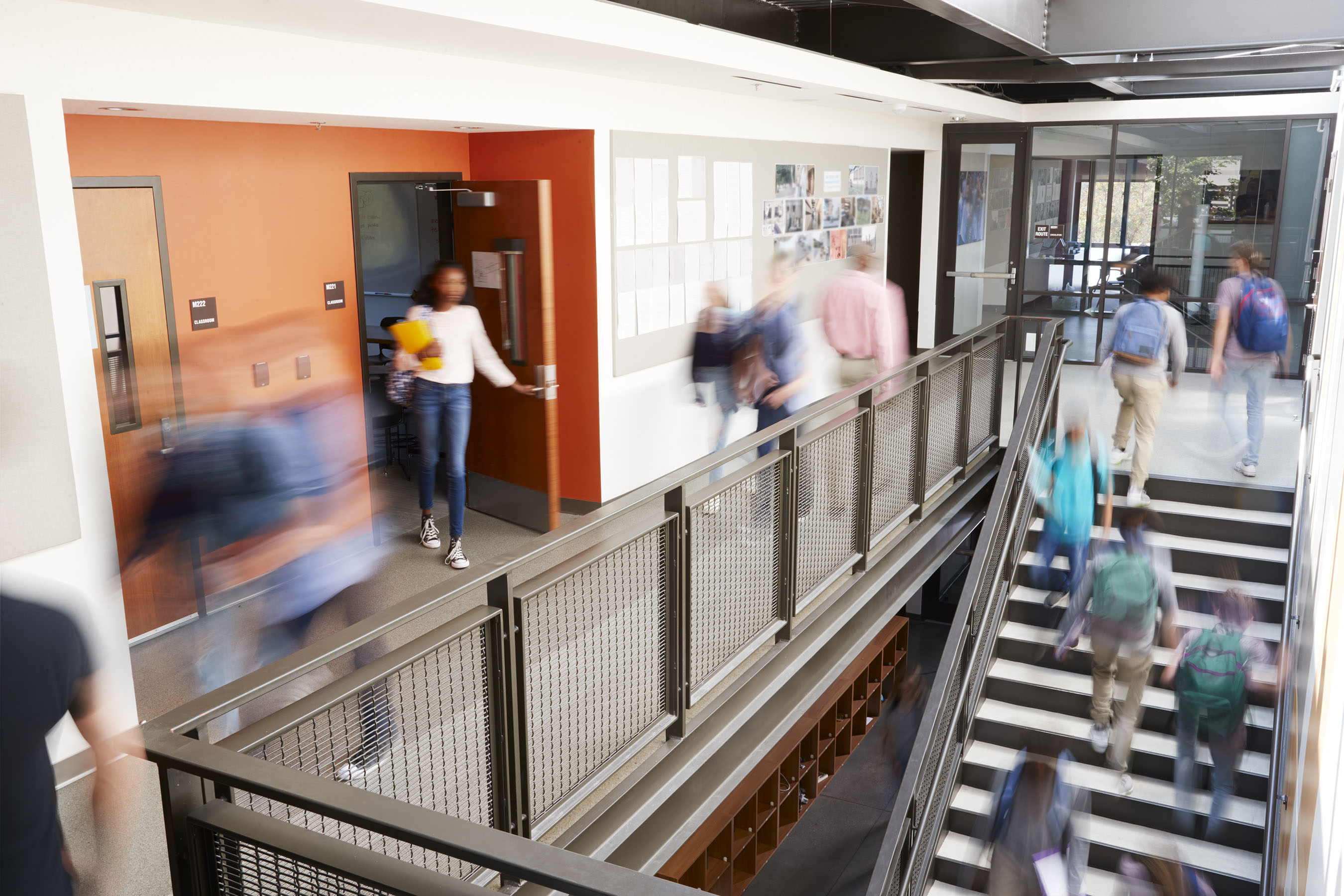 students changing classes in hallway and stairs
