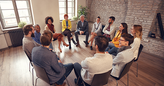 People sitting in a circle conducting a group therapy session