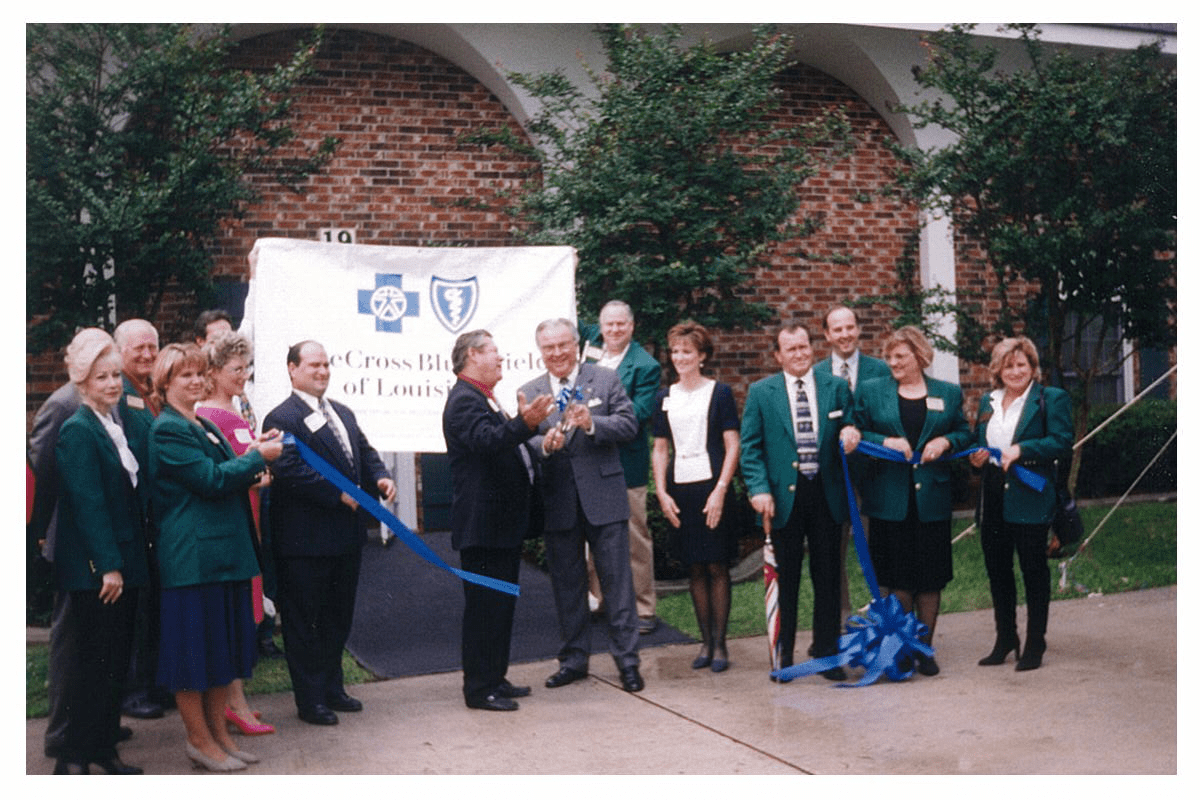 photo of PJ Mills cutting blue ribbon for Blue Cross and Blue Shield of Louisiana event; other people present
