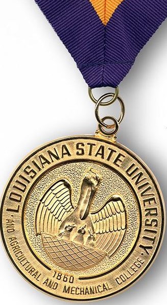 Gold University medal on a purple and gold string.
