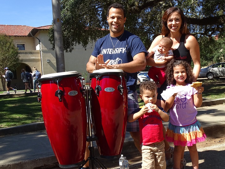 family smiling with drums