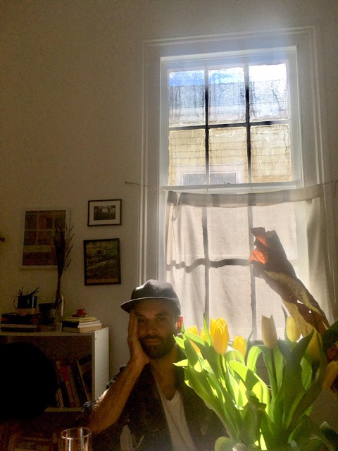 ian lockaby sitting in front of a window