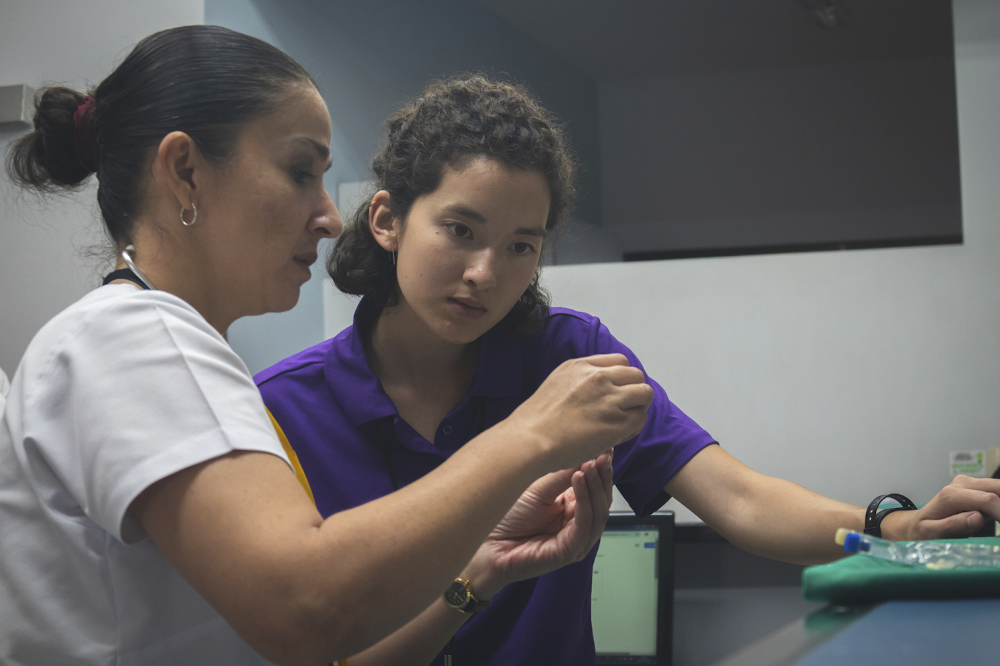 LSU student assists local nurse in Coopasana Clinic in San Jose, Costa Rica.