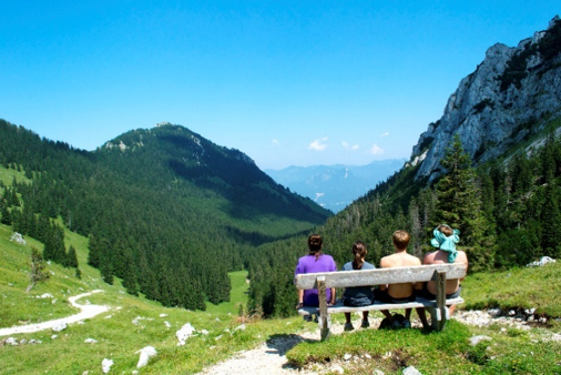 Students sitting on a bench with the view of a mountain