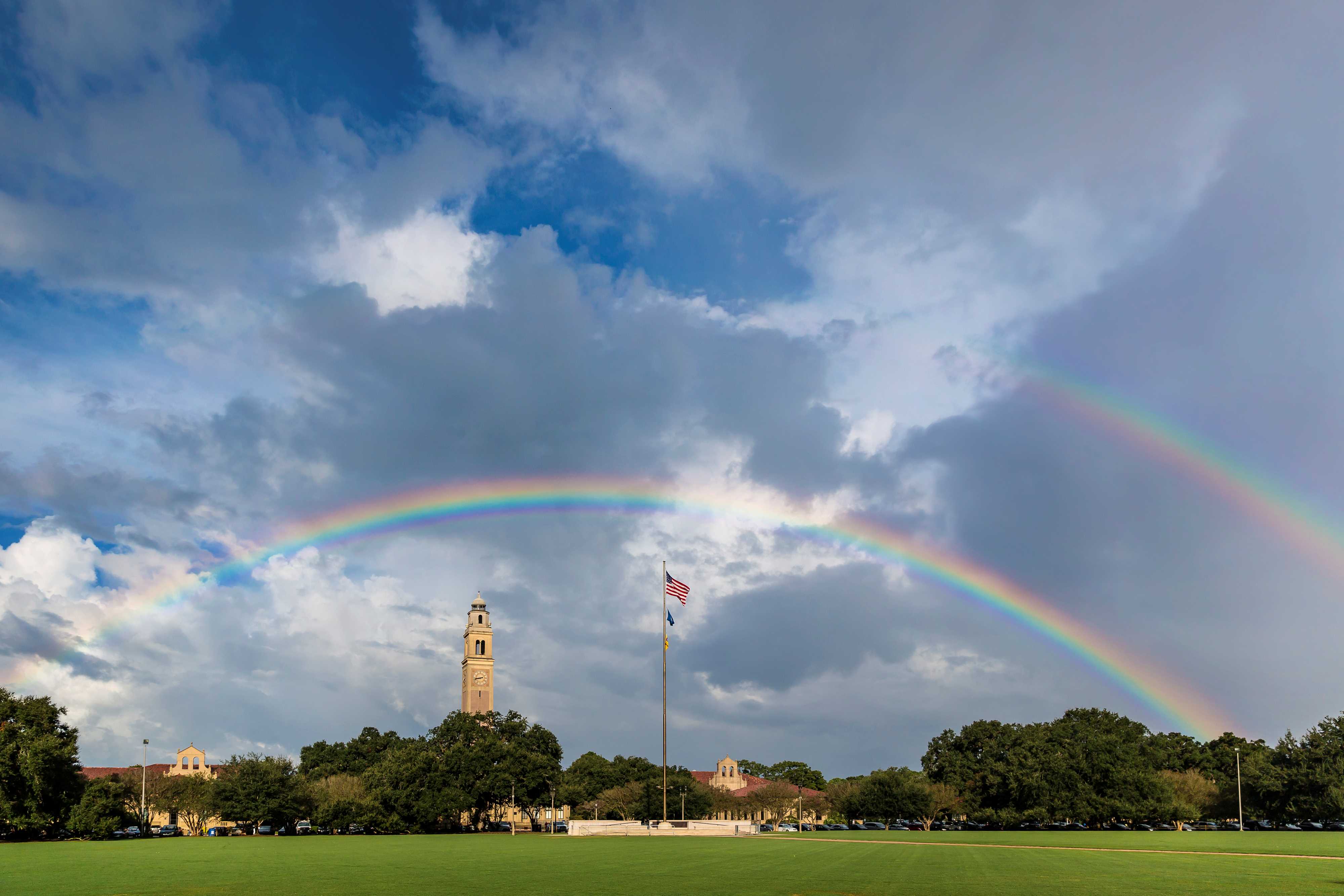 Memorial tower under a double rainbow.