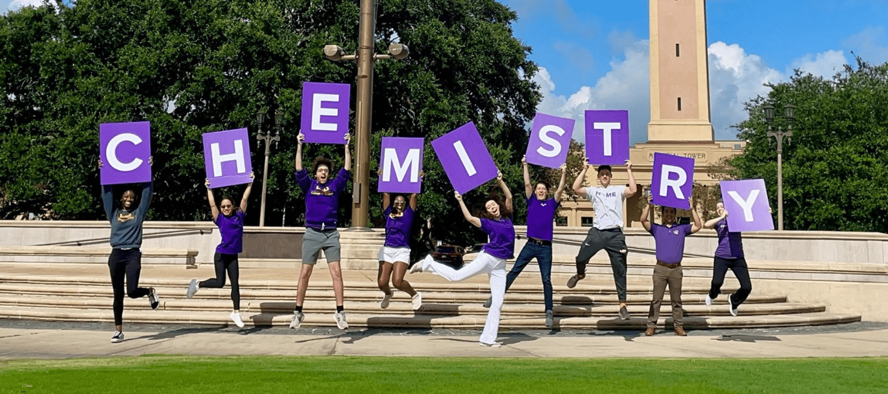 Chemistry students holding signs that spell chemistry