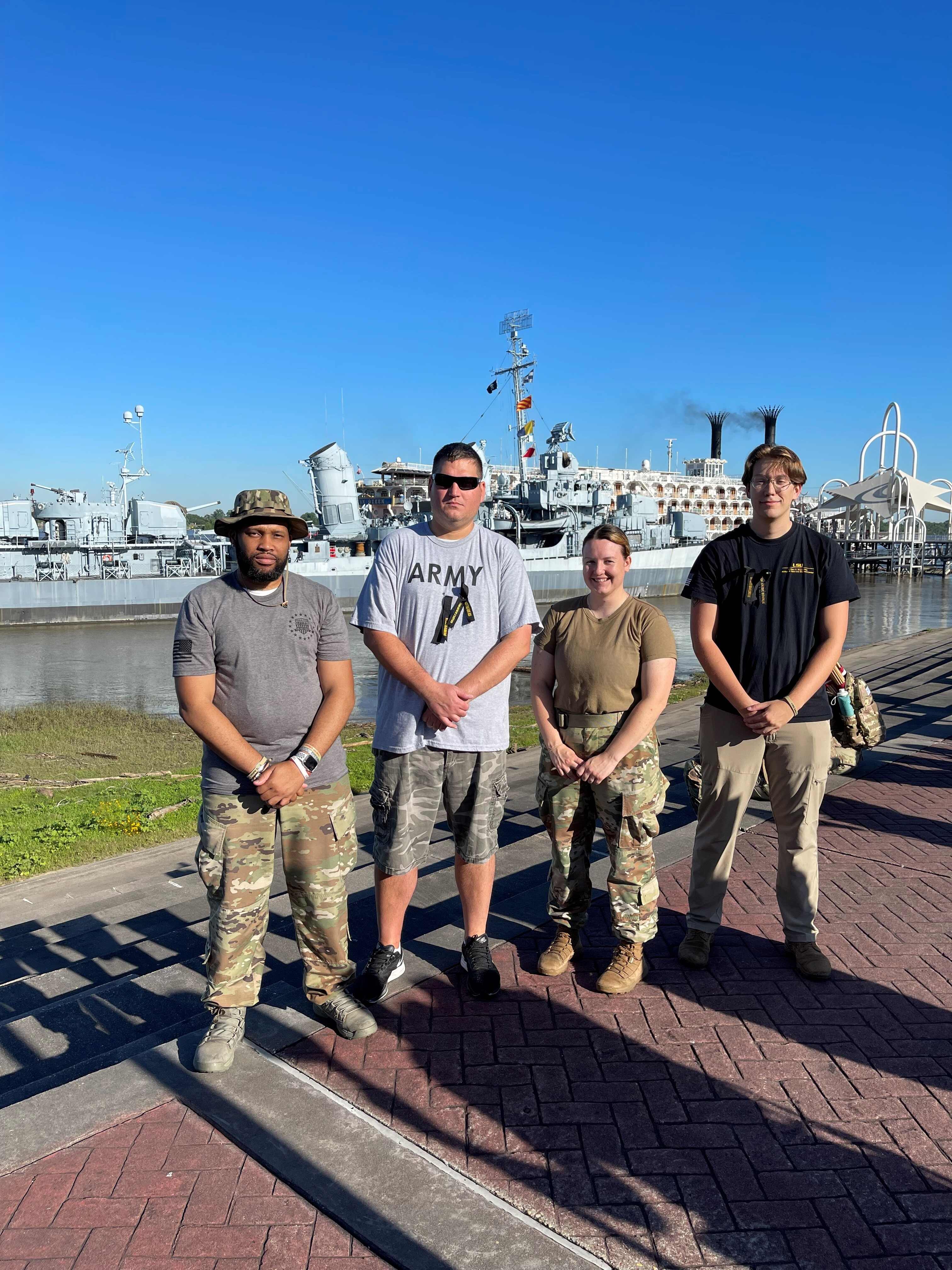 group of students stand at Baton Rouge Riverfront in front of a ship