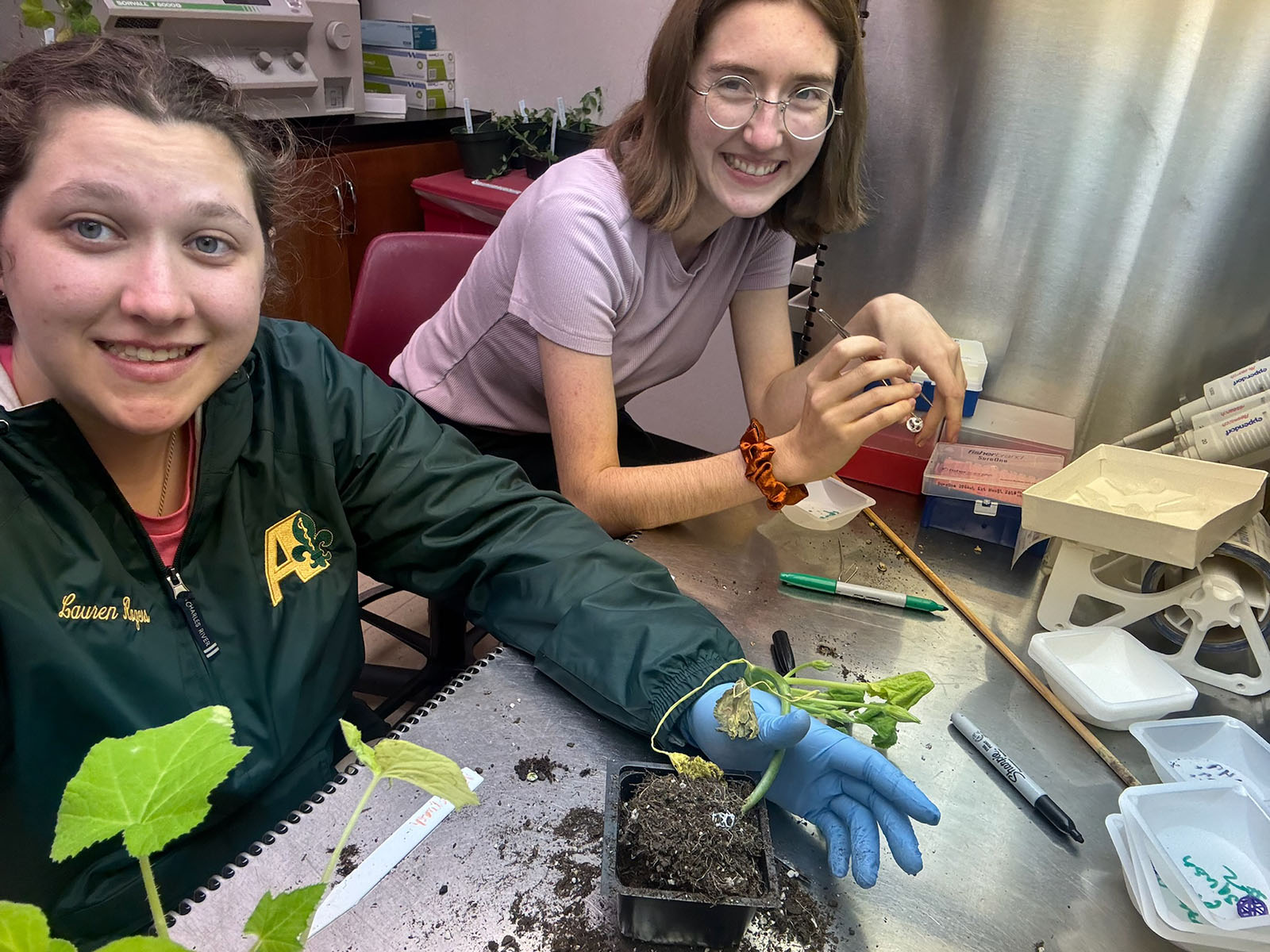 Lauren Rogers and Alexis Strain working with plants