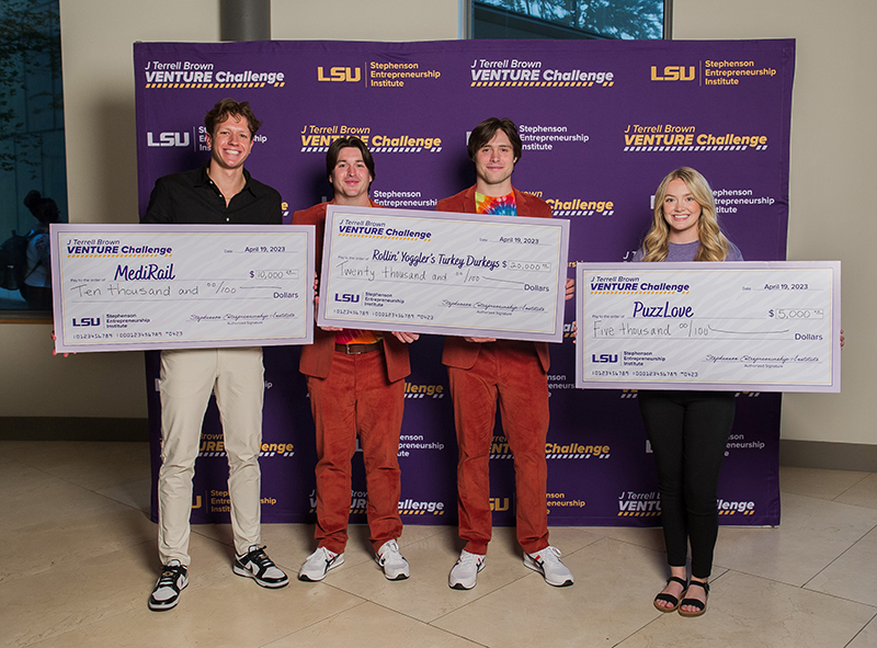 J Terrell Brown Venture Challenge winners hold large checks and smile