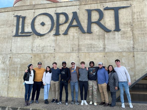 Group of students in front of Llopart winery sign in El Castos, Spain