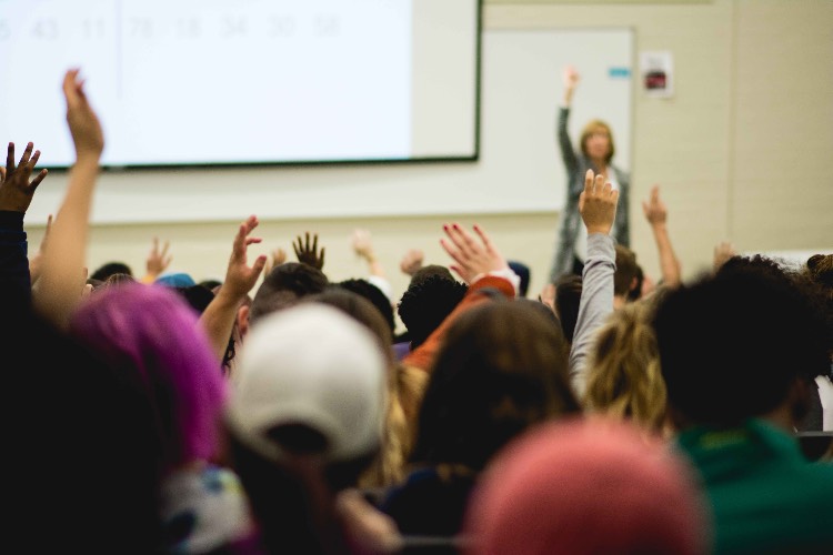 hands raised during classroom presentation