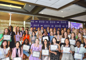 Group of students holding certificates at an award ceremony