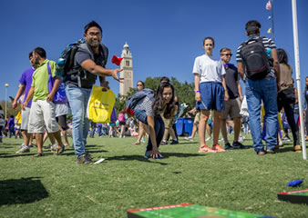 students playing beanbag toss